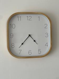 a clock is hanging on a wall at Appartement cosy proche Paris CDG RER B Disneyland Paris Parc Astérix in Le Blanc-Mesnil