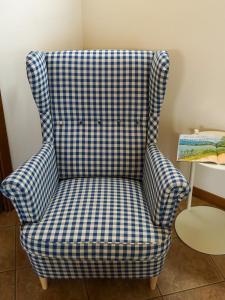 a blue and white checked chair in a room at Casa Vacanze al Lago P1 in Monasterolo del Castello +24 photos