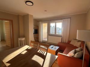 a living room with a bed and a couch at Gasthaus Schwielochsee in Friedland