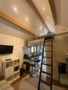 a room with a staircase and a living room with a desk at La villa dans les pins in Quend