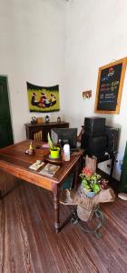 a room with a wooden table with food on it at Gran Casa Hostel&Camping in Tilcara