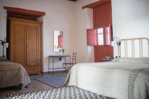 a bedroom with a bed and a table in it at La Casita de la Basílica in Pátzcuaro