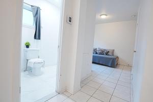 a hallway with a toilet and a couch in a room at Comfort Residence in Montreal +211 photos