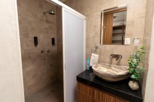 a bathroom with a stone sink and a shower at Habitación independencia in Morelia +21 photos