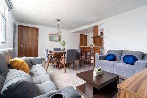 a living room with a couch and a table at Habitación independencia in Morelia