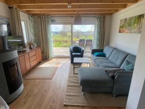 a living room with a couch and a tv at Schwedenhaus Fridhem mit Panoramablick auf dem Hügel in Monschau