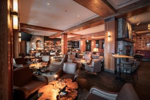 a restaurant with couches and tables and a bar at Nita Lake Lodge in Whistler