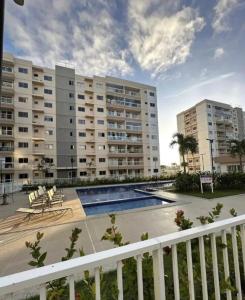 a view of a apartment complex with a swimming pool at Aracaju Apartamento 2 Quartos Proximo A Orla de Atalaia Praia de Aruana Aeroporto Shopping Sul in Aracaju