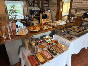 a buffet of food on two tables in a restaurant at Chateau Franz in Osek