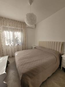 a bedroom with a large bed and a pendant light at Villa il Gabbiano Stintino in Stintino