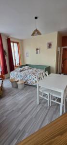 a bedroom with a bed and a table in it at Appartement Pierre in Mers-les-Bains