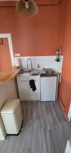 a small kitchen with a sink and a toilet at Appartement Pierre in Mers-les-Bains +6 photos
