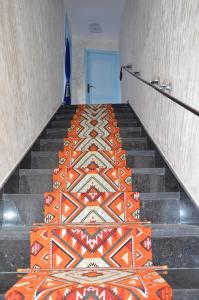 a stairway with an orange and white tile floor at Residence 33 bleu in Guelmim +1 photo