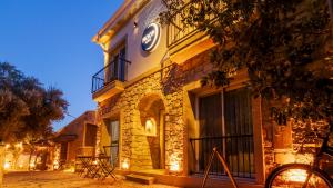 a building with a clock on the side of it at Moon Alaçatı adults only in Çeşme
