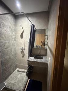 a bathroom with a sink and a shower at résidence avec piscine wifi et parking gratuit in Bouskoura +5 photos