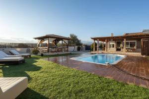 a backyard with a swimming pool and a gazebo at SENSEs VILLA SPA in Aghia Marina