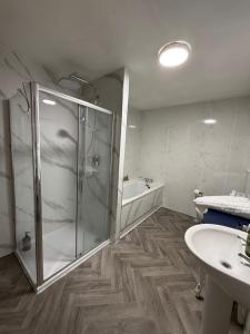 a bathroom with a shower and a sink at "SUPERB-SEA-VIEWS"ROOM ONLY at WETHERBY NAIRN in Nairn