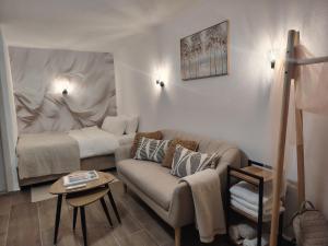 a living room with a couch and a bed at Studio BIANCA in Kotor