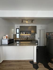 a kitchen with a counter top in a room at The Spring Collection in Tatu City
