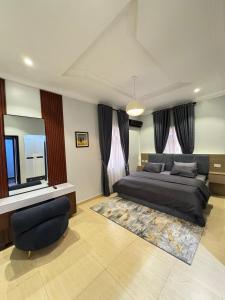 a bedroom with a large bed and a window at Klue Homes in Maiyegun