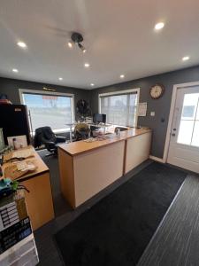 an office with a desk and a clock on the wall at Tulip Motel in Woodstock
