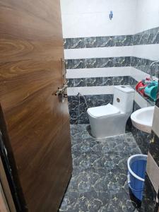 a bathroom with a toilet and a sink at Yatri room in Varanasi