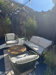 a patio with a bench and a table and chairs at EifelQuartier L9 in Schleiden