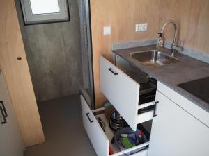a small kitchen with a sink and a counter at Buorkerijhûske A - Tussen Wad en Weide in Hallum