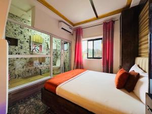 a bedroom with a bed and a large window at La Castrol Hotel Apartments in Limbe +76 photos