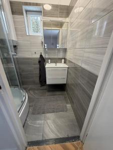 a bathroom with a sink and a tub and a mirror at Fifteenapartman in Balatonföldvár +13 photos