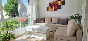 a living room with a couch and a coffee table at Departamento PH en Martinez in Martínez