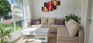 a living room with a couch and a table at Departamento PH en Martinez in Martínez