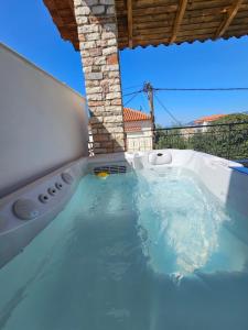 a hot tub in the backyard of a house at Central Apartments in Kardamyli