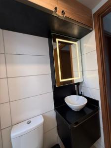 a bathroom with a sink and a toilet and a mirror at 098house havana in São Luís