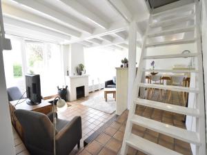 a living room with a white ladder in a room at Holiday Home Warmenhuizen near Dunes in Warmenhuizen +28 photos