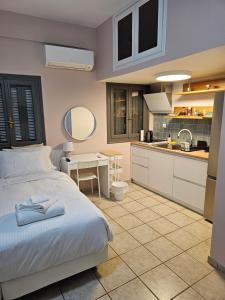 a bedroom with a bed and a kitchen at Central Apartments in Kardamyli