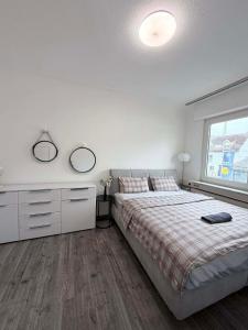 a bedroom with a bed and two mirrors on the wall at Privatzimmer in Gemeinschaft Zimmer 5 in Leimen +6 photos