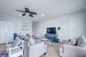 a living room with two couches and a ceiling fan at Oceanview home in Crystal Beach