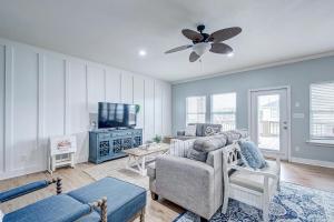a living room with a couch and a tv at Oceanview home in Crystal Beach