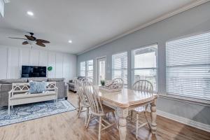 a living room with a table and chairs and a couch at Oceanview home in Crystal Beach