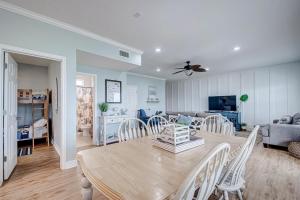 a dining room and living room with a table and chairs at Oceanview home in Crystal Beach