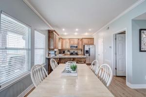 a dining room with a table and chairs and a kitchen at Oceanview home in Crystal Beach +18 photos