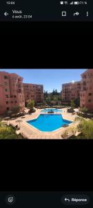 a screenshot of a video of a swimming pool at إقامة أطلس جيليز in Oulad Akkou