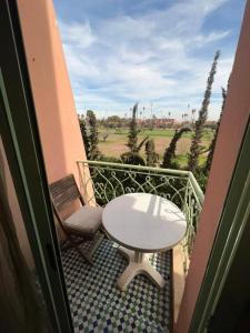 a table and a chair on a balcony with a view at إقامة أطلس جيليز in Oulad Akkou