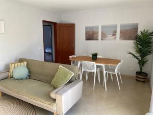a living room with a couch and a table at Esteves Apartment - Alvor Center in Alvor