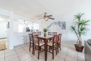 a dining room and kitchen with a table and chairs at Sandcastles - Cocoa Beach Oceanfront Condos with Heated Pool Tennis in Cocoa Beach