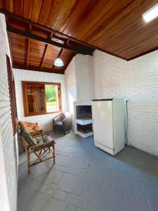 a living room with a refrigerator and a couch at hotel fazenda ctk in Santa Cruz do Sul