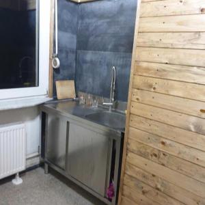 a kitchen with a sink and a wooden wall at Privatzimmer in Gemeinschaft Zimmer 5 in Leimen