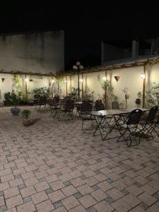 a patio with a table and chairs at night at Privatzimmer in Gemeinschaft Zimmer 5 in Leimen