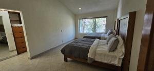 a bedroom with two beds and a window at Casa Velero in Puerto Vallarta